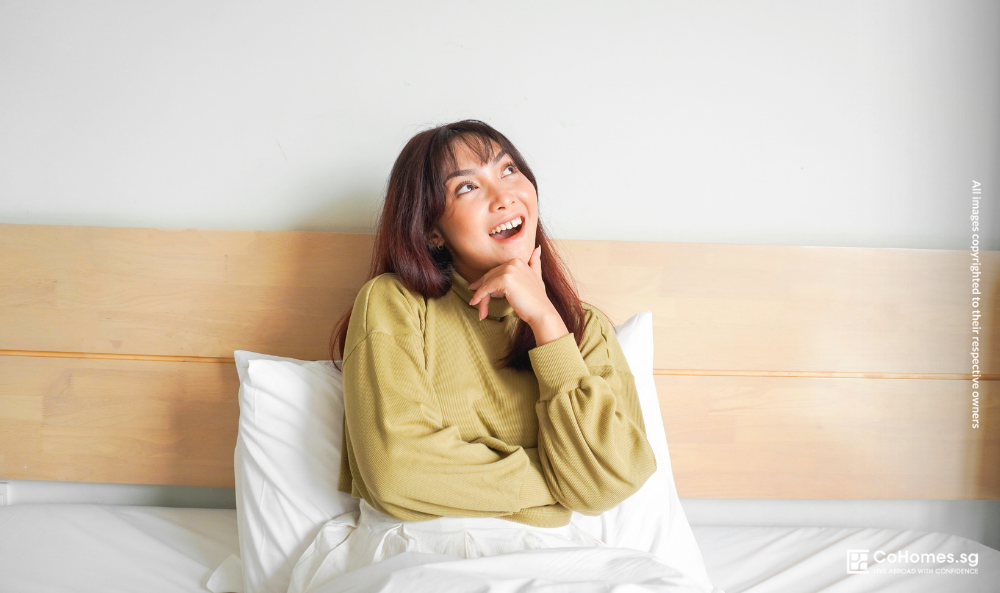 Young Singapore renter enjoying a comfortable co-living room while prioritising lifestyle experiences over larger living spaces.