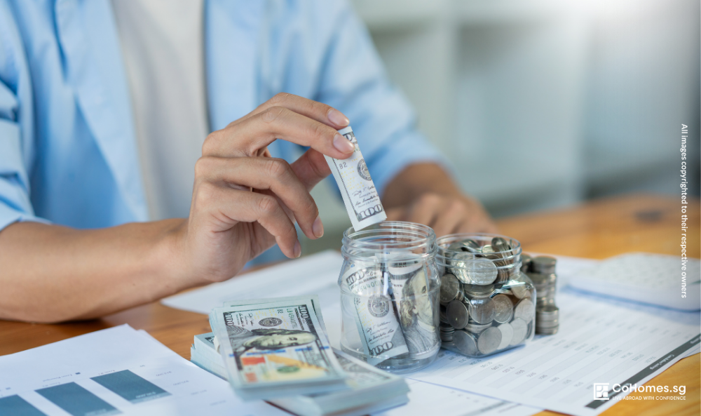 Renter saving cash in a jar to build an emergency fund while managing rental expenses in Singapore.