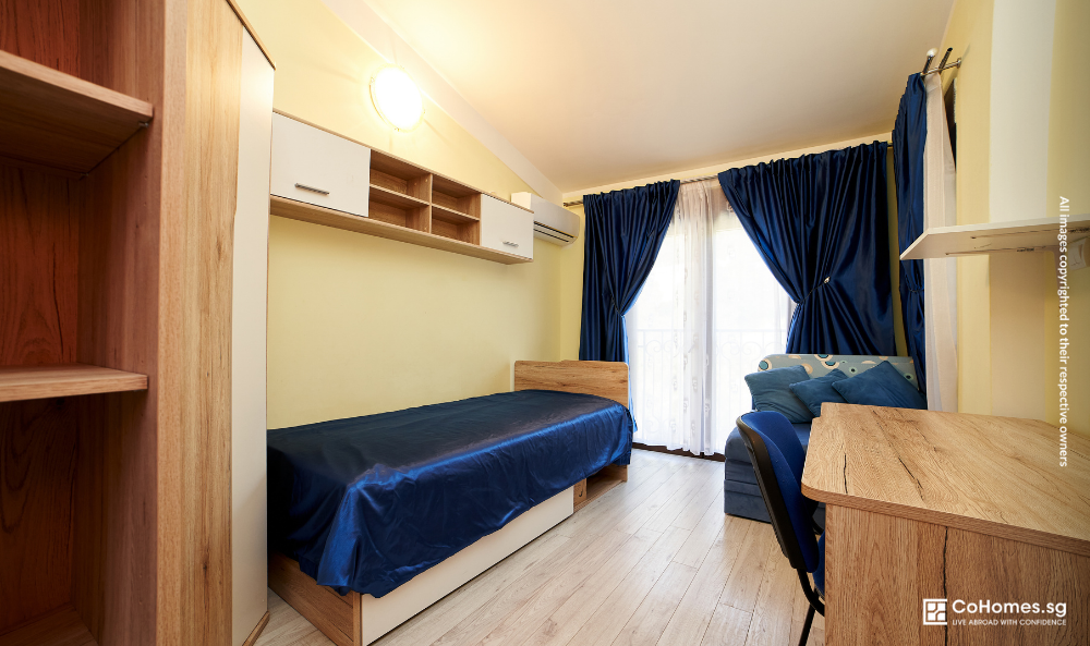 Empty rental room with bed and curtains