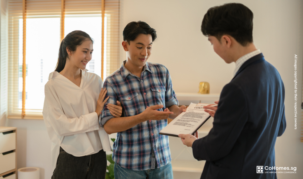 Tenants discussing a rental agreement with a property agent